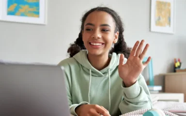 Girl saying hi to the computer camera