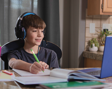 Boy taking notes at home