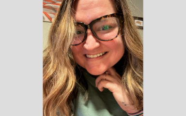 Woman smiling and wearing glasses